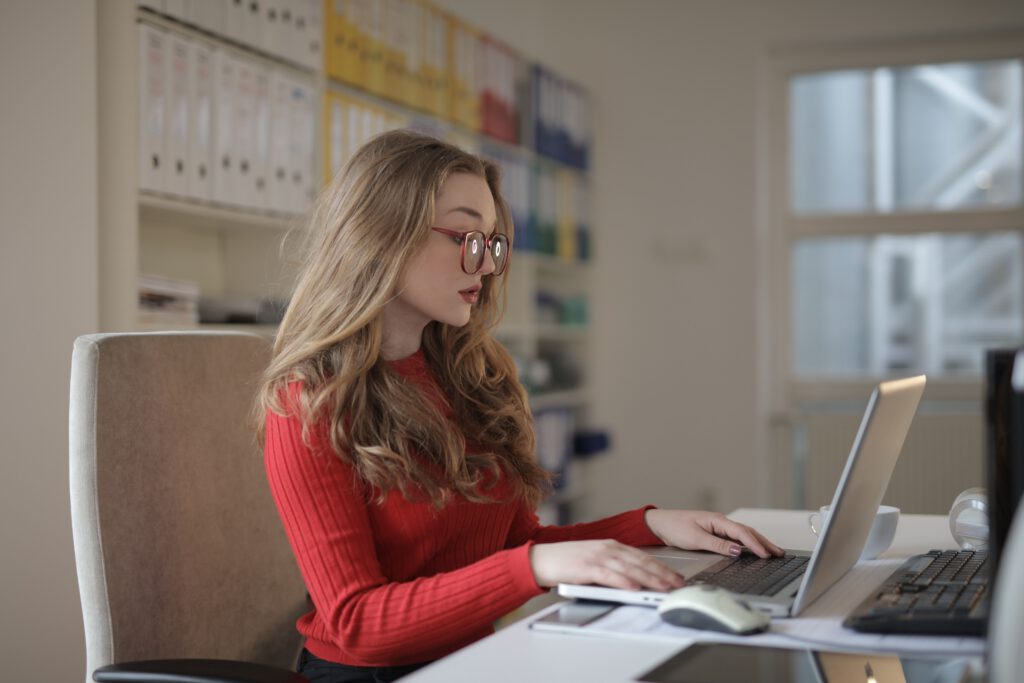 Woman actively working at a computer with focus and momentum