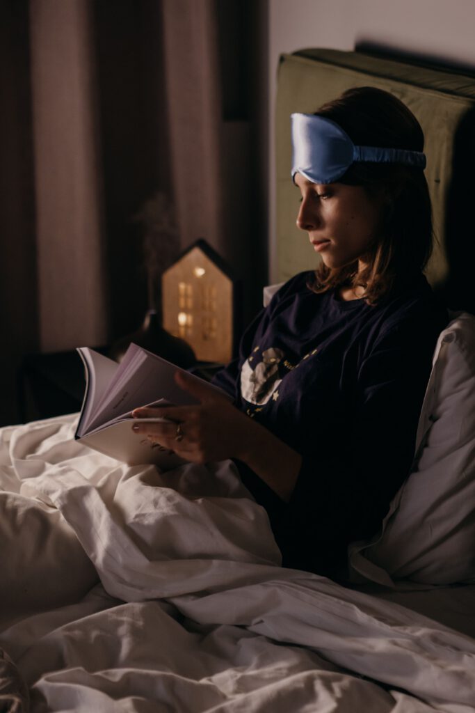 Woman reading in bed during a calm evening before sleep