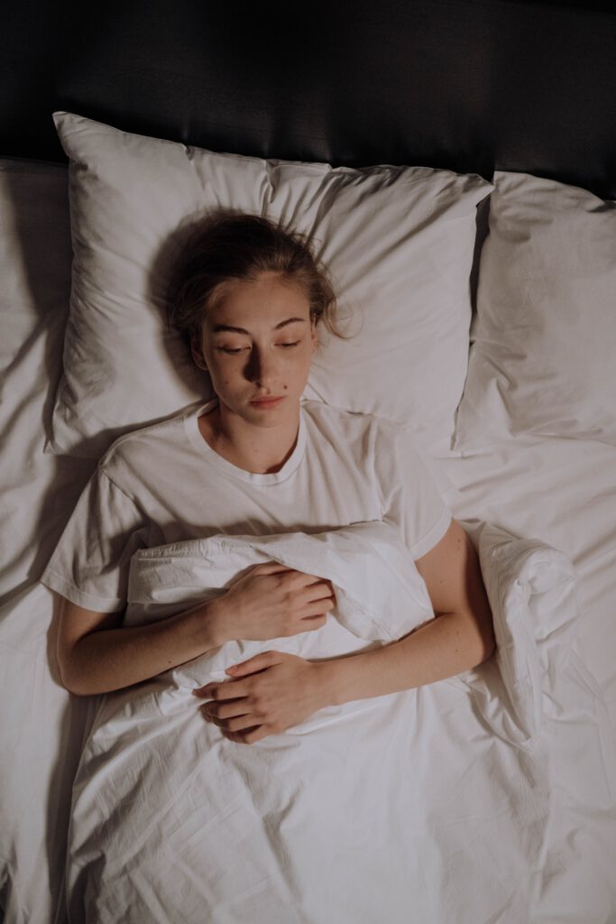Woman lying awake in bed at night