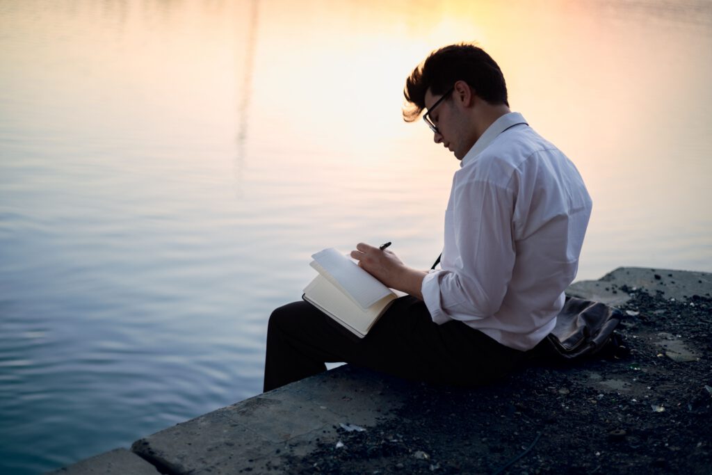 Man reflecting quietly beside the water