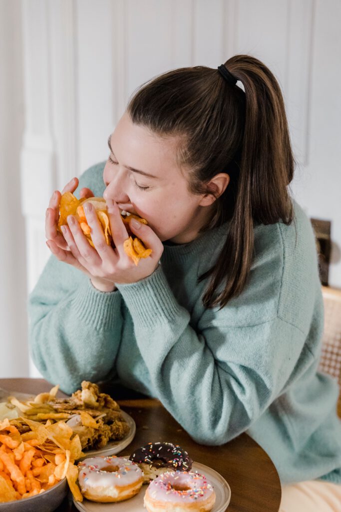 Woman eating comfort food representing emotional and habitual eating patterns