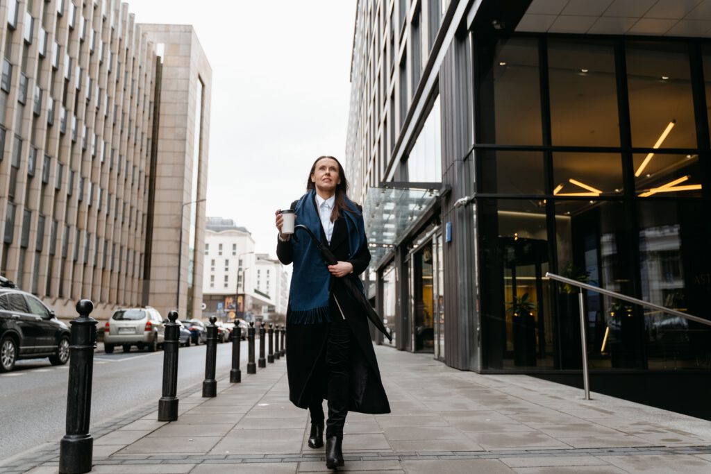 Woman walking confidently through the city representing everyday life and positive change